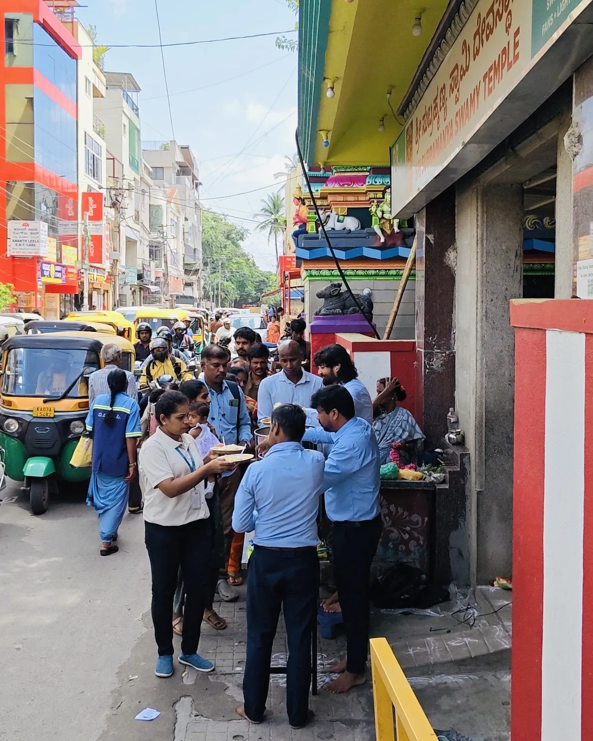 Dr. Chetan Kumar Mehta serving Anna Danam meals outside a temple, Bengaluru street