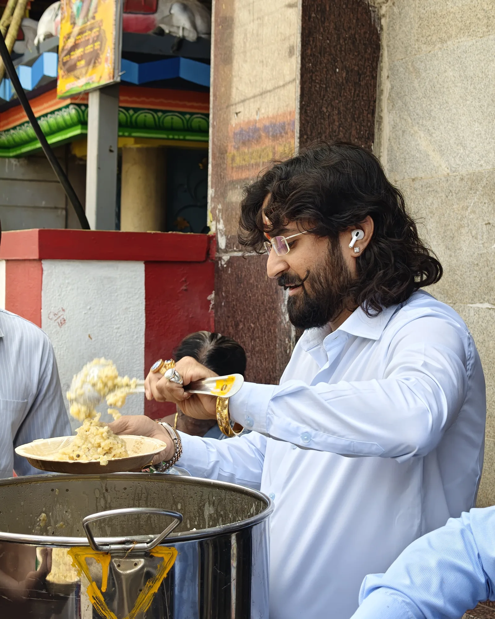 Dr. Chetan Kumar Mehta close-up, serving Anna Danam meals at a temple feeding stop