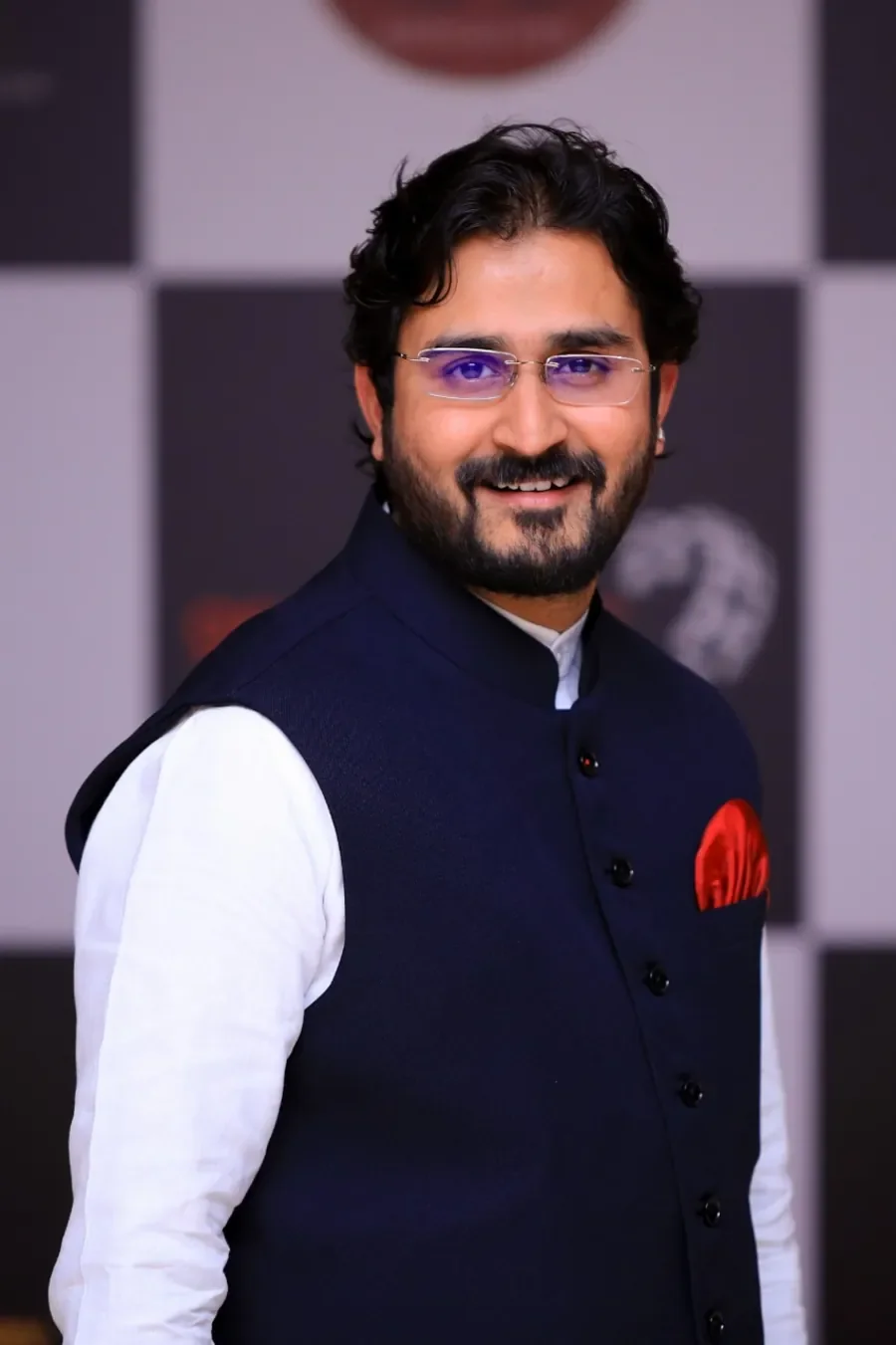 Dr. Chetan Kumar Mehta in a navy Nehru vest, portrait