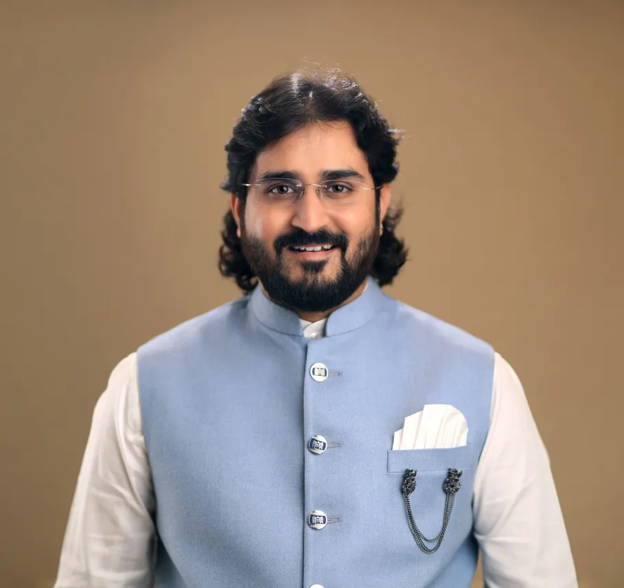Dr. Chetan Kumar Mehta in a light-blue Nehru vest, portrait